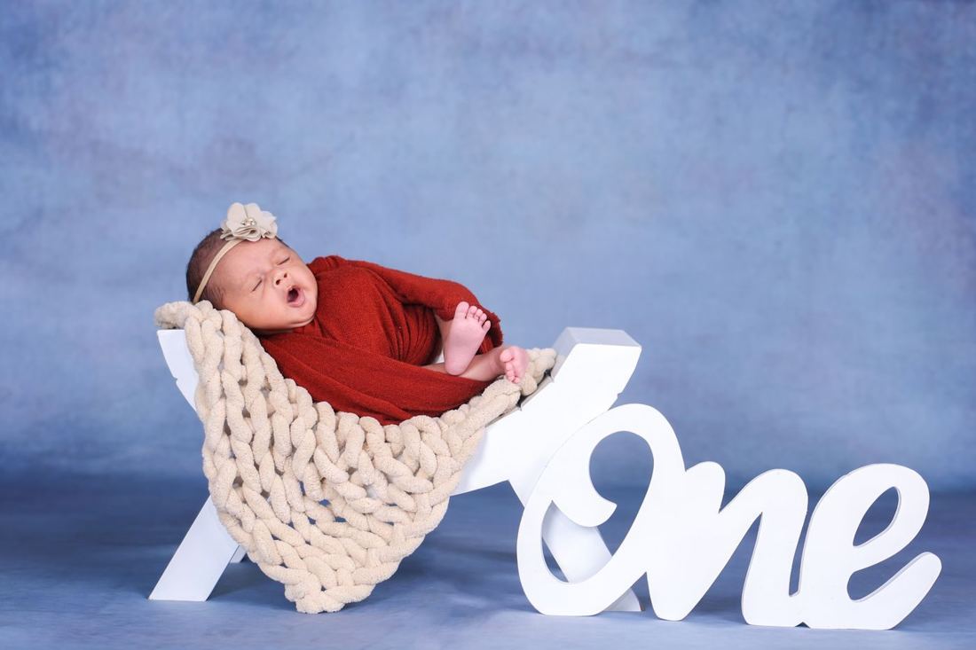 Baby with a ONE prop for a first birthday shoot