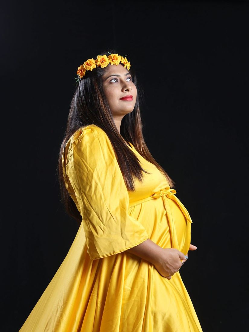 Mother-to-be in a yellow dress with a flower crown