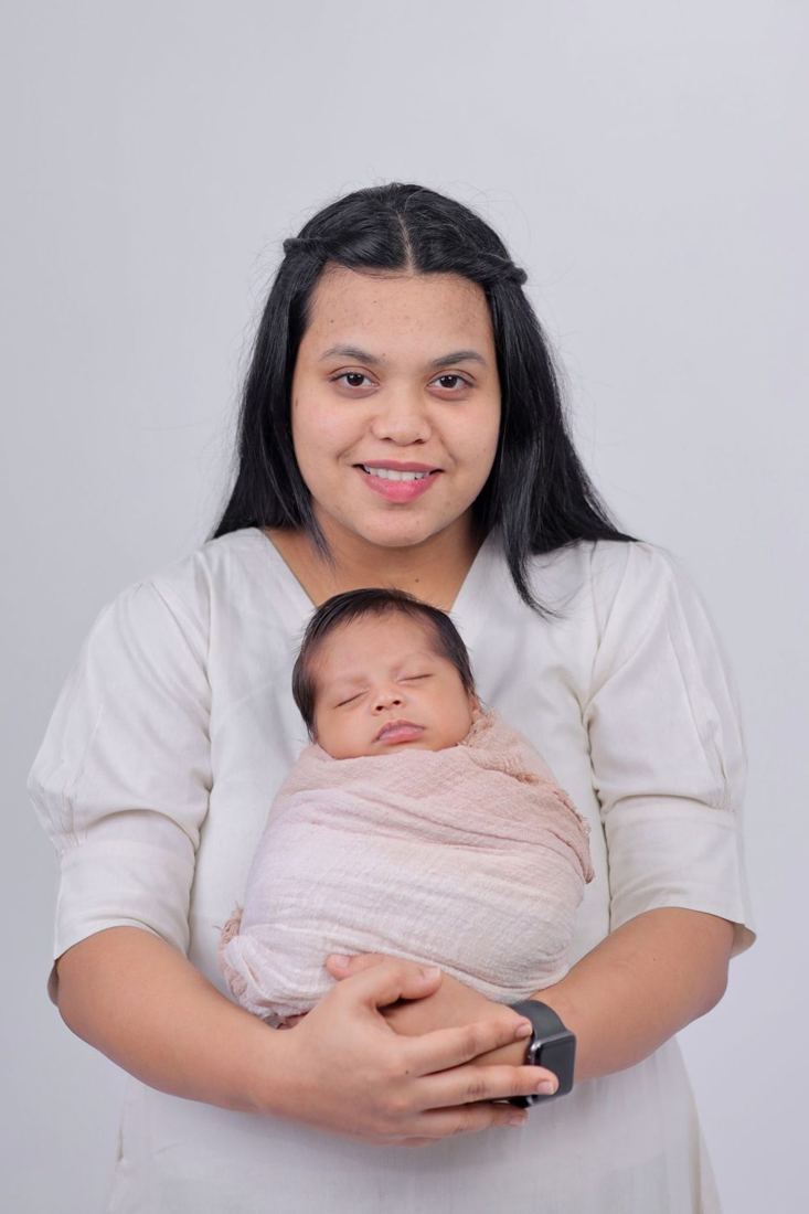Mother holding her newborn wrapped in a blanket