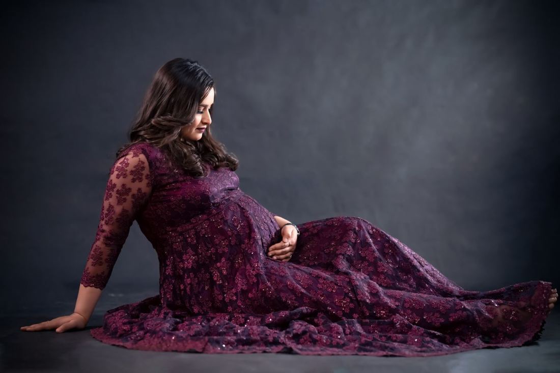 Mother-to-be in an embroidered purple gown
